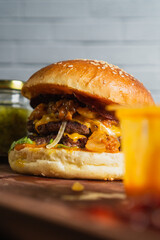 closed up smash beef burger with cheese, coney sauce on wooden table