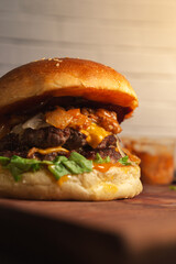 closed up smash beef burger with cheese, coney sauce on wooden table
