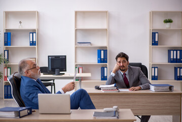 Two male colleagues working in the office