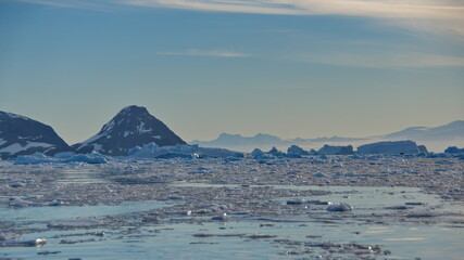Icebergs floating in Cierva Cove, Antarctica, at sunset
