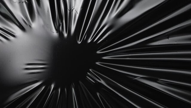 The plastic film melts and breaks. On a black background, use the overlay mode.