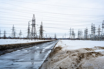 The spring puddles, snow, road, electric poles and wires.