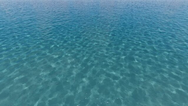 High quality Looping animation of ocean waves from underwater with floating plancton. Light rays shining through. Great popular marine Background