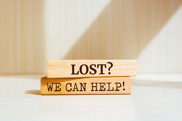 Wooden blocks with words 'Lost? We Can Help!'.