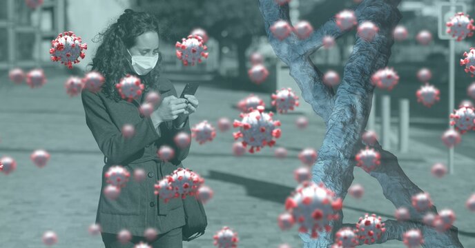 Covid-19 cells and DNA structure against woman wearing face mask using smartphone