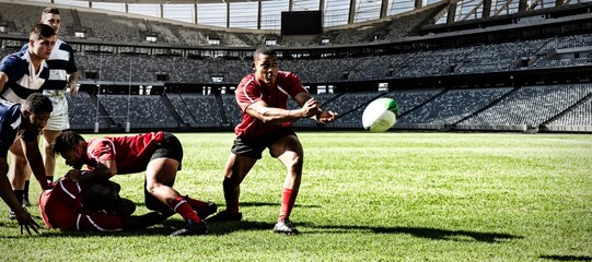 Digital composite image of rugby player throwing the ball to his teammate in sports stadium