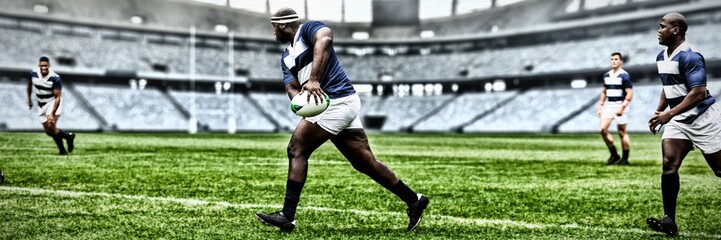 Digital composite image of rugby player throwing the ball to his teammate in sports stadium