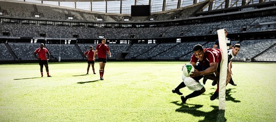 Digital composite image of two rugby players tackling each other in sports stadium