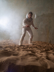 Fear of the unknown on alien planets. An astronaut in a white spacesuit walks through an abandoned...