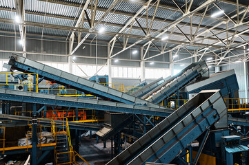Conveyor carries trash pieces in recycling plant workshop