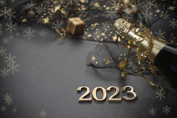 Fototapeta na wymiar New Year concept, with bright light and champagne bottle, golden bokeh background