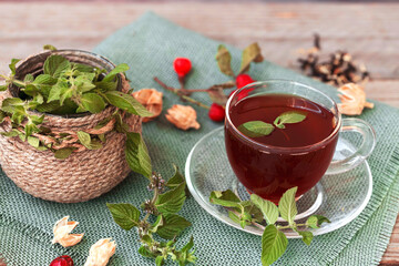 Hot tea with rose hips and herbs in a glass bowl. Drink containing vitamin C and antioxidants.