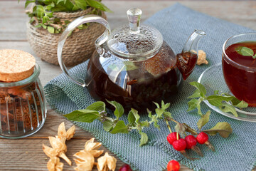 Hot tea with rose hips and herbs in a glass bowl. Drink containing vitamin C and antioxidants.