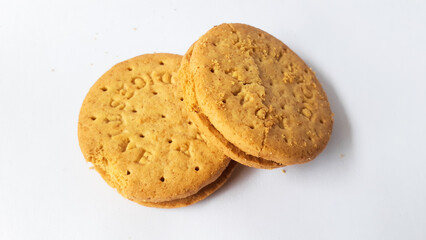 BISCUITS - Delicious wheat round biscuits with a few crumbs isolated on white