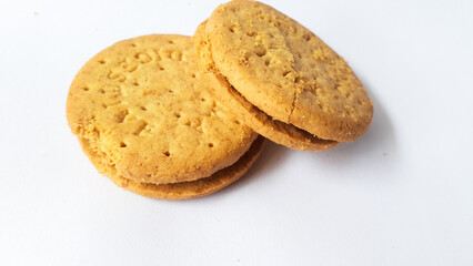 BISCUITS - Delicious wheat round biscuits with a few crumbs isolated on white