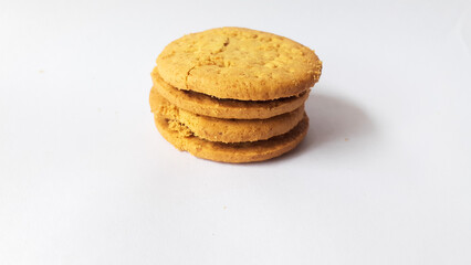 BISCUITS - Delicious wheat round biscuits with a few crumbs isolated on white