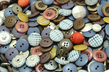 Multi-colored sewing buttons of different sizes and shapes background