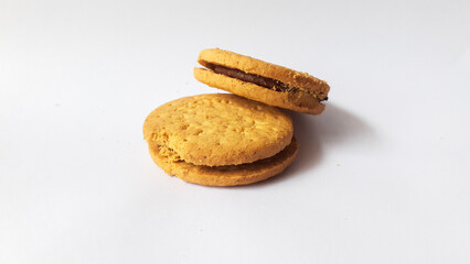 A stack of delicious wheat round biscuits with chocolate filling isolated on white background