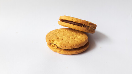 BISCUITS - Delicious wheat round biscuits with a few crumbs isolated on white