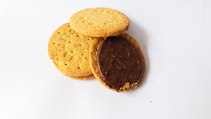 A stack of delicious wheat round biscuits with chocolate filling isolated on white background