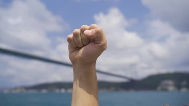 Revolutionary hand gesture. Symbol.
Revolutionary hand gesture by the sea. Symbolic revolutionary fist.
