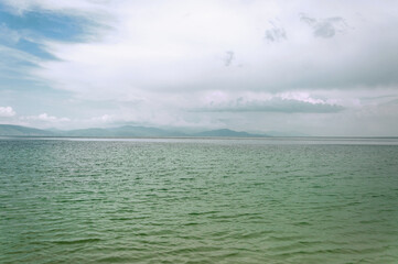 Seascape. Mountain lake shore. A pond with emerald-colored water.  Lake Sevan in Armenia.