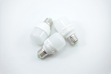 concept of three small white energy-saving light bulbs isolated on a white
