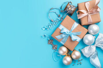 Christmas background with balloons, gifts and decorations on a blue background. Merry Christmas and Happy New Year. Top view, copy space