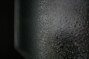 Water droplets on the mirror, black background 