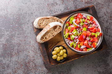 Trampo is a typical peppers tomatoes salad in Majorca Spain closeup on the wooden board on the table. Horizontal top view from above
