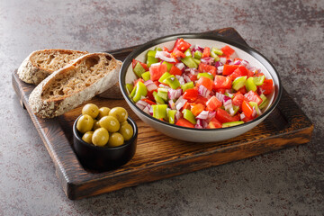Trampo is a typical peppers tomatoes salad in Majorca Spain closeup on the wooden board on the...