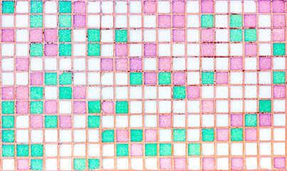 Bright pink, green and white small square ceramic retro tiles textured background.