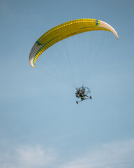  paramotor flying over the town of Vang Vieng on a sunny morning