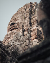Siem Reap, Cambodia - March 18th, 2020 : face of the Buddha carved in stone at Bayon temple in the Angkor Wat religious complex