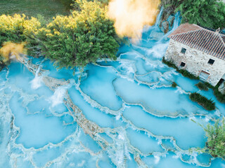 Fototapeta na wymiar View from above, stunning aerial view of Le Cascate del Mulino, a group of beautiful hot springs in the municipality of Manciano, Tuscany.