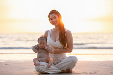 Happy baby boy is snuggling with mom is the most warmest moment. An innocent Asian kid is chubby,...