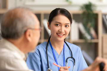 Asian doctor woman visited senior or elderly patient to diagnosis and check up health at home.Happy elderly enjoy cheerful with doctor or nurse on couch.Health care premium service at home