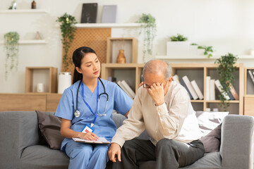 The doctor put her hand on the shoulder of worried old man, caring and comforting depressed...