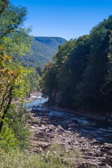 Fototapeta na wymiar Stormy mountain river in a granite canyon