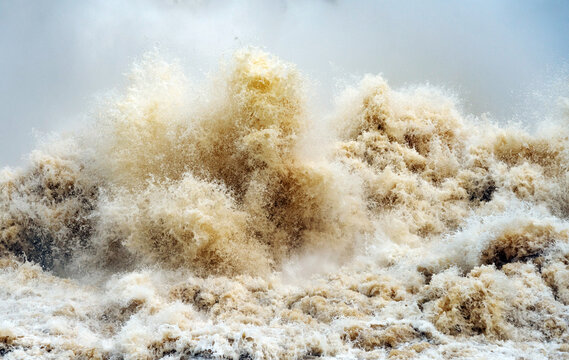 Close Up Of Gushing Water Spraying Out From Over Full Dam.