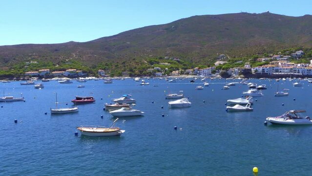 Small pleasure boats docked in the sea near the pretty coastal village of Cadaques, Girona, Spain.