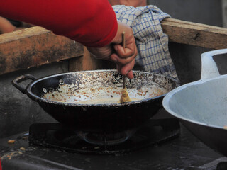 chef preparing food in a pan