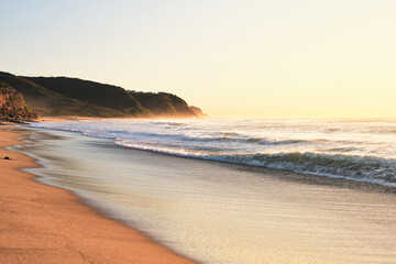 Ocean waves washing in over Burwood beach, New South Wales, Australia during sunrise