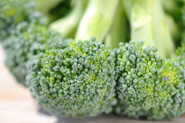 Broccoli cabbage on a light background before cooking closeup. Shallow depth of field