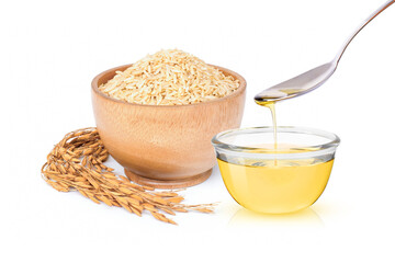 Rice bran oil with paddy and brown rice isolated on white background.