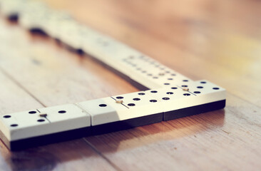 A family playing domino game in a wooden table