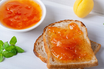 Toasts of bread with apricot jam and fresh fruits with mint