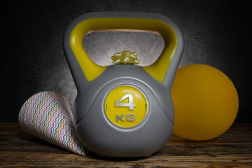 Heavy kettlebell with a bow, balloon and cone hat. Exercise equipment as a birthday party gift...