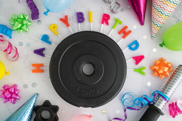 Dumbbell barbell weight plates with colorful Happy Birthday cake candles letters, balloons, cone...