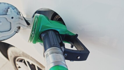 Gas Station Fuel Gasoline Pump Nozzle Pistol Inserted into Car Tank Filler Hatch Parallax